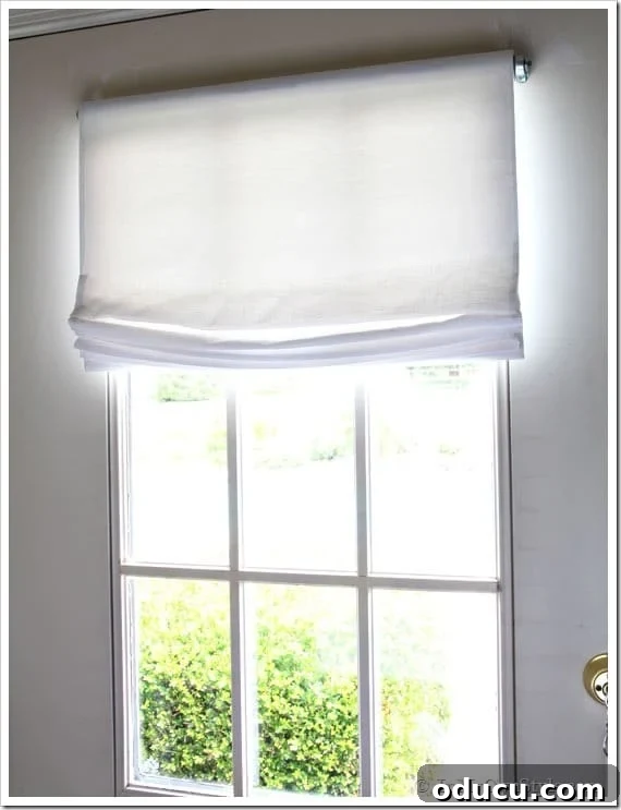Detailed step-by-step instructions for creating a no-sew Roman shade with illustrative pictures. Close-up of DIY no-sew Roman shade on a window