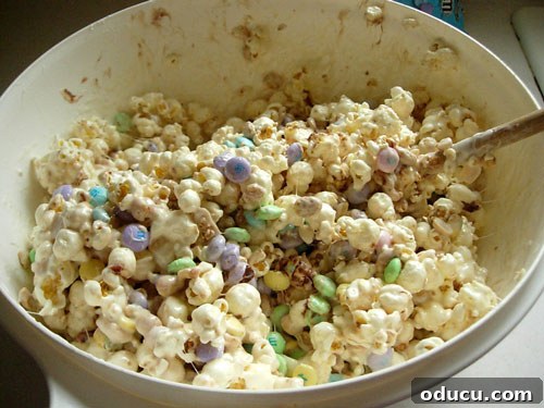 Popcorn-cake-mixed in bowl The fully mixed popcorn cake ingredients, a sticky and colorful blend, ready to be shaped.