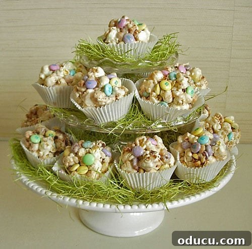 Popcorn-cakes made from recipe on Easter decorated plate Finished popcorn cakes nestled in cupcake liners, displayed on an Easter-decorated plate, showcasing their individual charm.