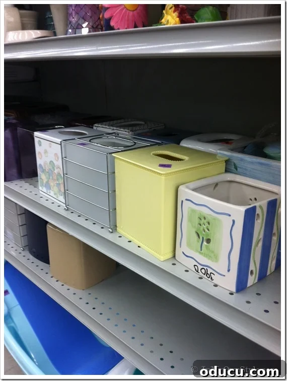 tissue boxes on a shelf at a thrift store and ideas on how to decorate them. tissue boxes at the Thrift store