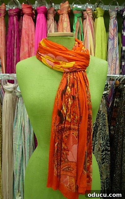 Scarf-Orange An orange scarf tied in a neat slip knot, offering a snug and stylish fit around the neck.