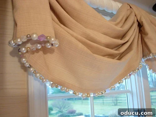 Elegant Kitchen Window Valance with Beaded Trim Beautiful kitchen window valance adorned with intricate beaded trim, enhancing the room's aesthetic.
