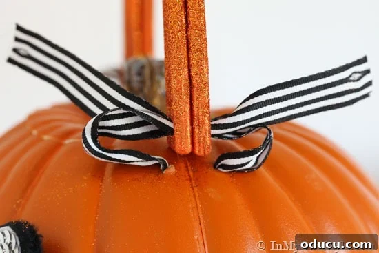 Whimsical Pumpkin Carving Ideas for Halloween 13 Attach ribbon on pumpkin with a double knot