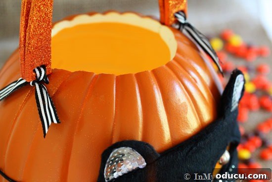 Whimsical Pumpkin Carving Ideas for Halloween 14 Close up of ribbon ties holding handles onto pumpkin.