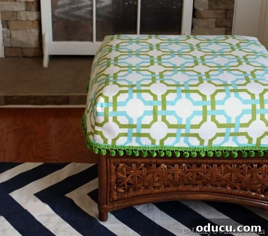 How-to-make-a-cushion-cover-for-an-ottoman Finished easy DIY cushion cover for an ottoman, showcasing the beautiful fabric and decorative trim, ready to enhance any room.