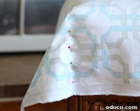 How-to-sew-a-cushion-cover-with-Waverly-Fabric Detailed view of fabric being prepared for an easy ottoman cushion cover, highlighting the start of the sewing process with Waverly fabric.