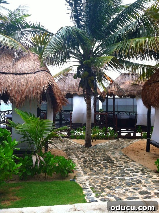 Tranquil Beachfront Massage Huts Relaxing massage huts scattered along the beachfront at El Dorado Royale, offering serene spa treatments.