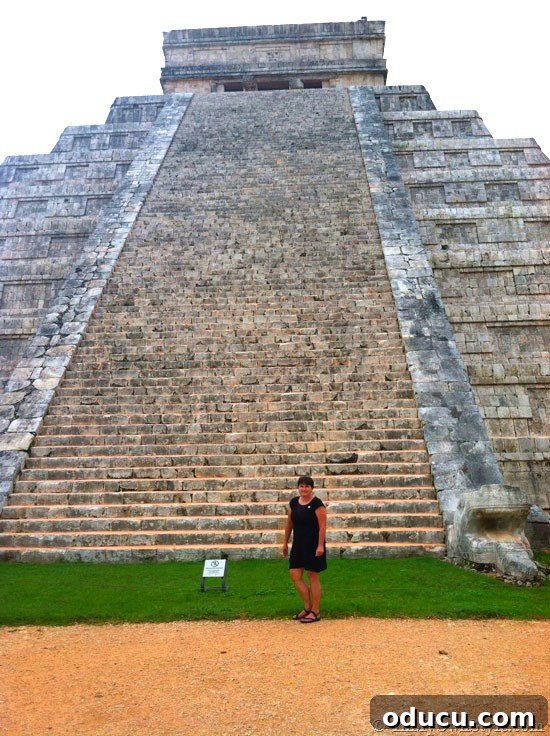 Diane at the Ancient Chichen Itza Diane standing in front of the magnificent ancient structures at Chichen Itza, a significant Mayan archaeological site.
