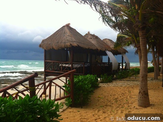 Stormy Weather Over Beach Huts Beach huts under stormy weather, signaling the end of a beautiful vacation in the Riviera Maya.