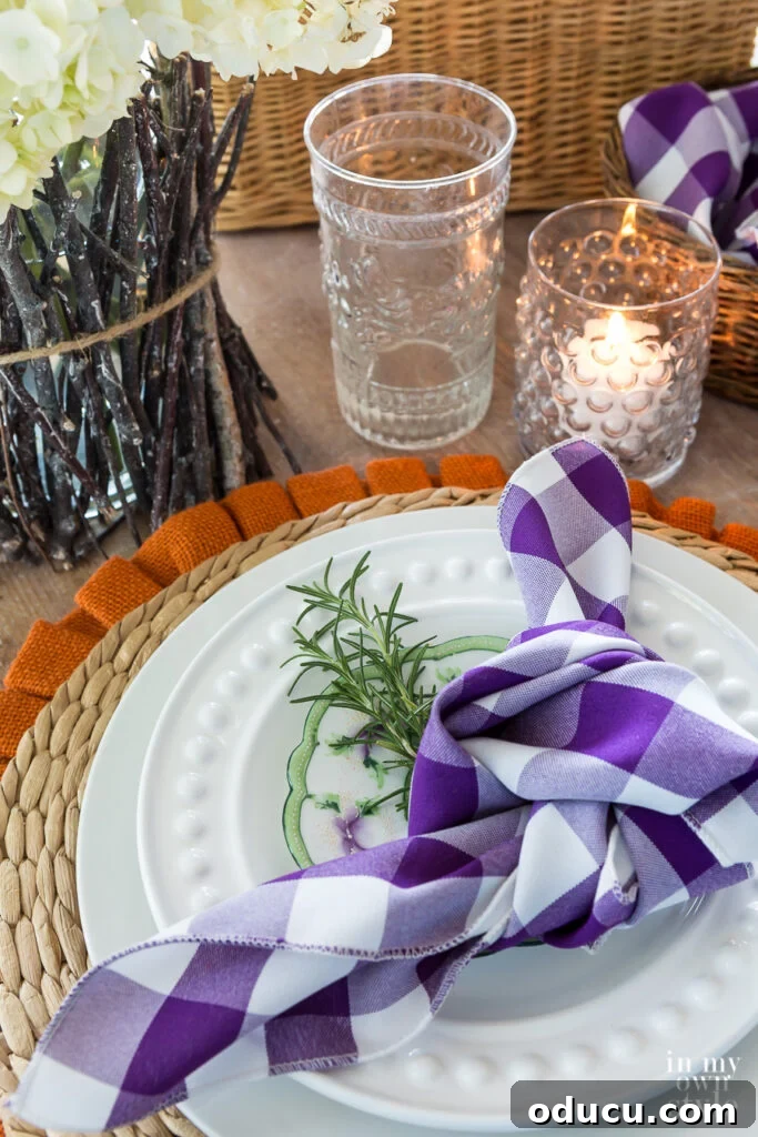 Fall inspired Table setting with a purple and white buffalo checked napkin, showing budget-friendly elegance.