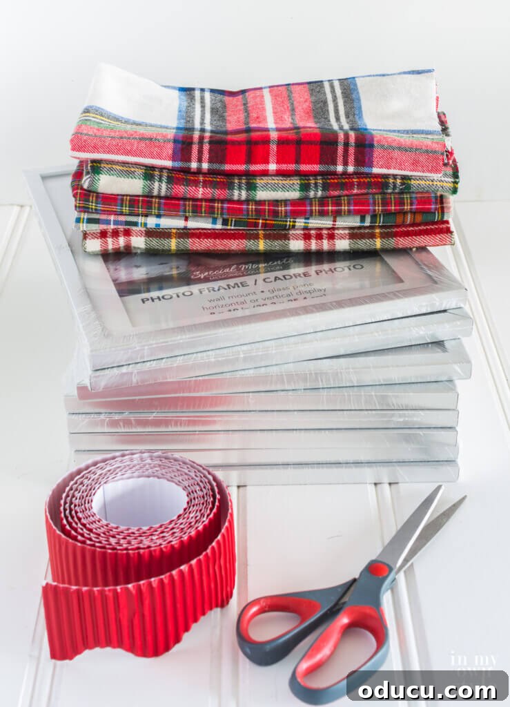 Upcycled Photo Frame Christmas Tree Skirt 5 An organized display of supplies needed for a DIY fabric-wrapped photo frame Christmas tree collar, including frames, fabric, cardboard, and a stapler.