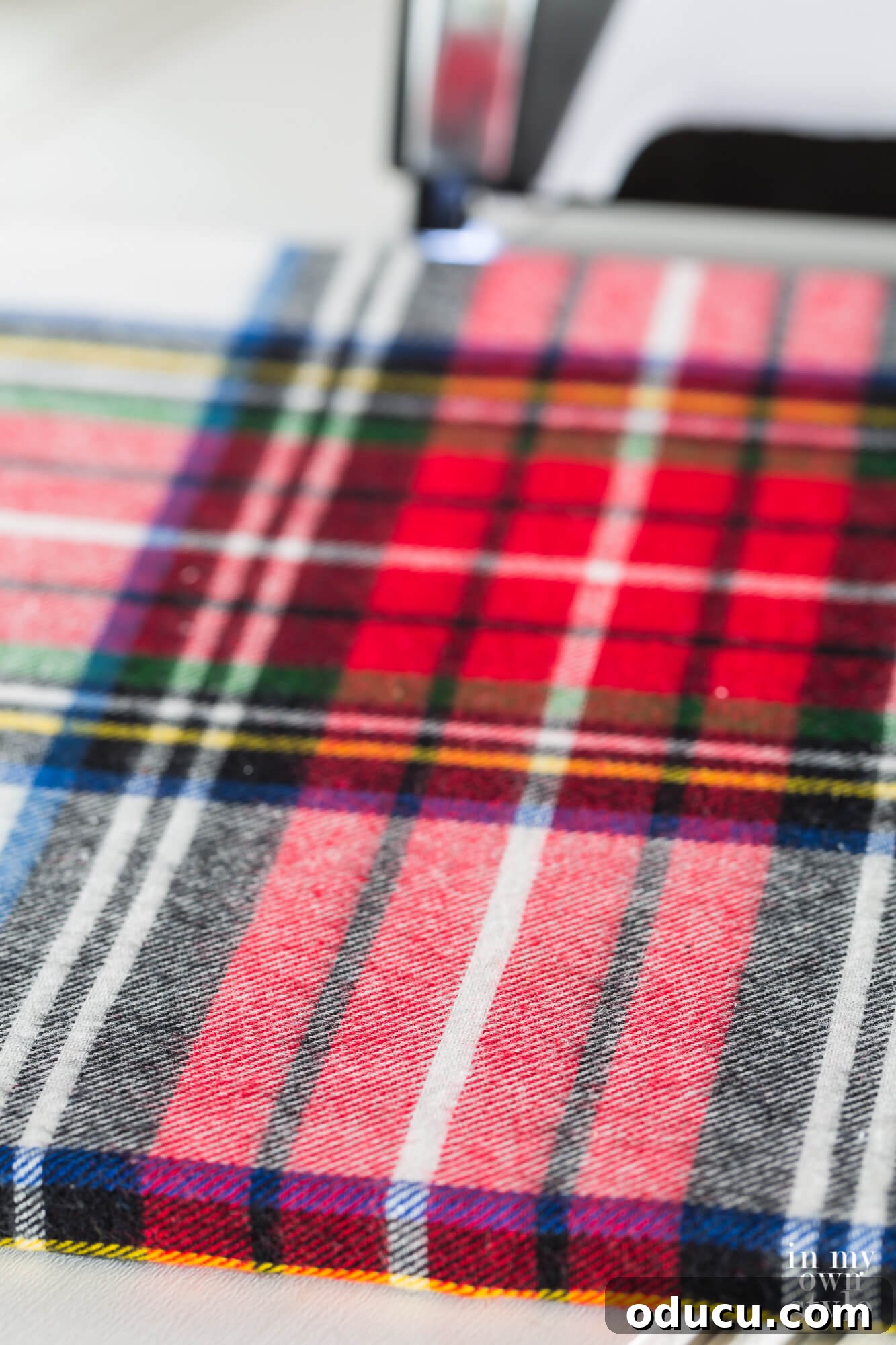 Upcycled Photo Frame Christmas Tree Skirt 10 A plaid fabric-wrapped photo frame, meticulously prepared and ready to be assembled into a stylish wrap-around Christmas tree stand, showcasing detailed craftsmanship.