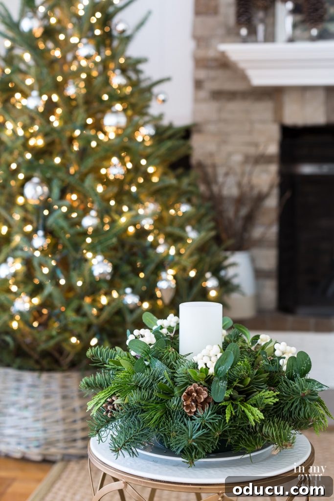Finished Christmas tree with fresh greenery centerpiece and glittered basket collar