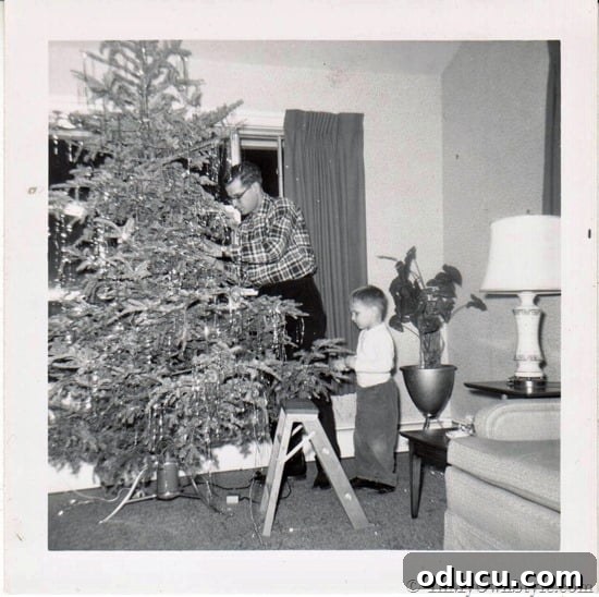 Foolproof Christmas Tree Lighting for a Dazzling Display 3 An old family photo showing a Christmas tree lit with traditional lights, capturing the festive spirit of past holidays.