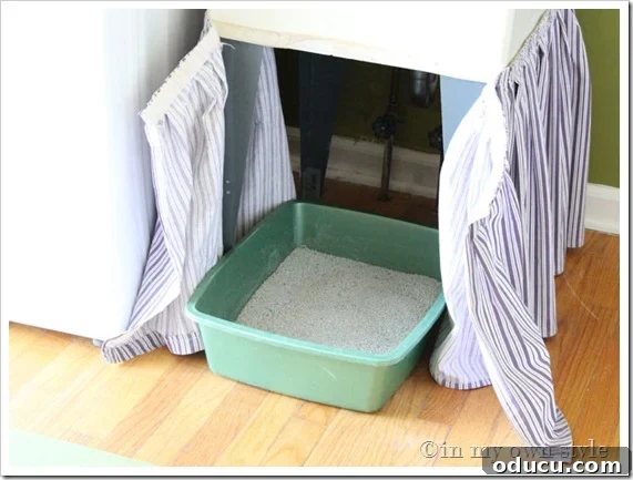 Crafting a Custom Sink Skirt 2 Skirted fabric attached around a laundry room tub sink makes for a good place to hide a litter box that allows the cat to still easily use it.