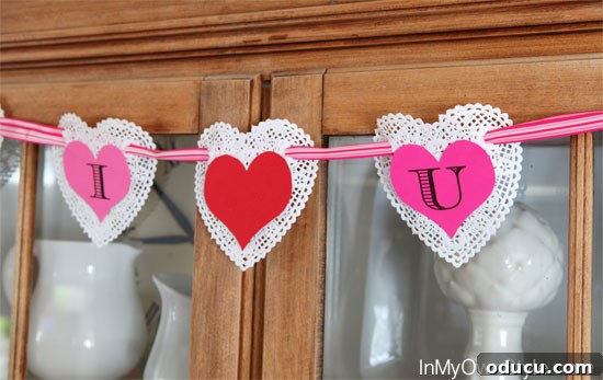 Heartfelt Initial Crafts: Free Valentine Printables 6 Creative Valentine's Day decorating idea: a handmade doily heart banner adding a romantic touch to home decor.