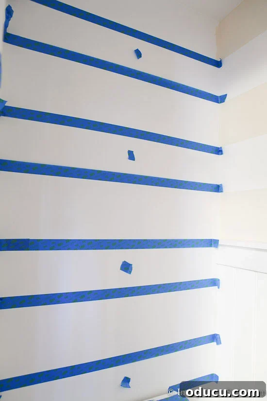Elevate Any Room with Perfectly Painted Horizontal Stripes 2 how to place painter's tape on wall when painting horizontal stripes on wall.