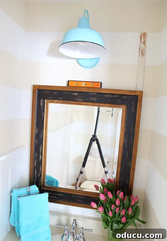 Instant Wall Decor: Hang Art & Mirrors Like a Pro 4 Close-up of the picture hanging gadget in action, hooked onto the back of a mirror.