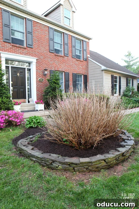 Transform Your Garden with a Hand-Built Fieldstone Wall 3 Mulched flower beds accented by a new fieldstone wall for spring blooms
