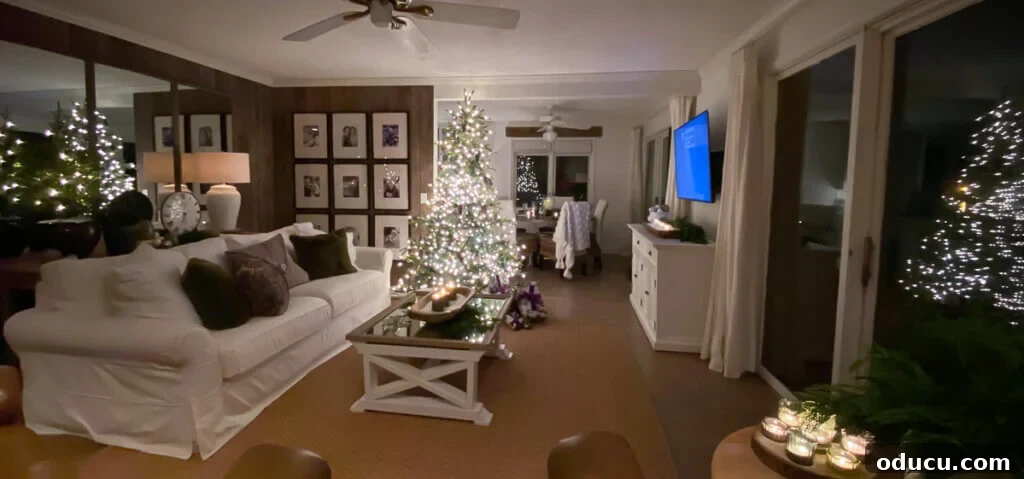 Valspar Bistro White Paint: Real Room Inspiration Gallery 4 Wide angle shot at night of living room that looks like there are 4 Christmas trees in reflections.