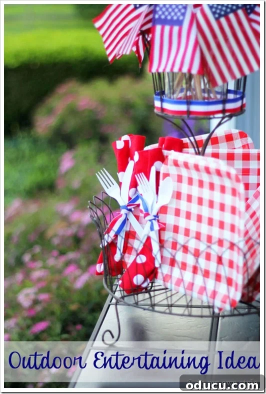Stars, Stripes, and Sparkles: My Fourth of July Decor 4 4th of July buffet table settings with pre-tied plastic utensils and napkins on paper plates for easy entertaining.