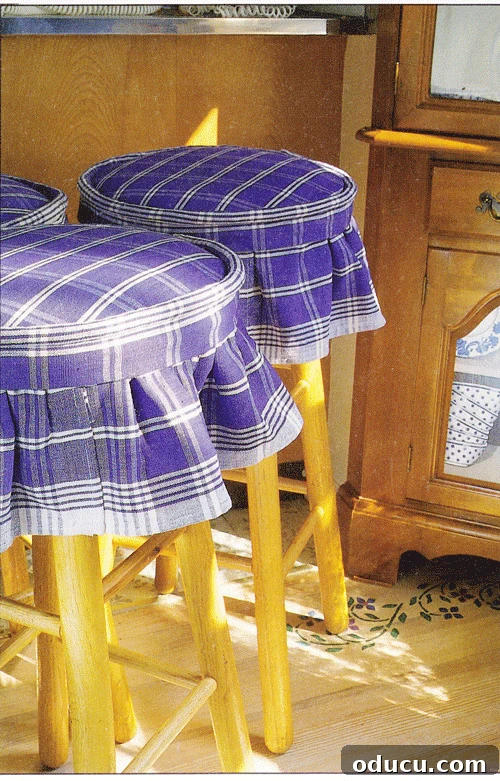 Blue and white skirted fabric stool top covers beautifully adorning kitchen stools.
