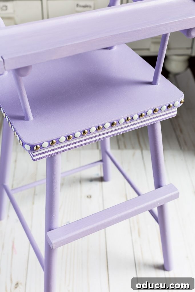 Ribbon Flair for Instant Home Style 13 Close-up shot of a Lavender painted high chair using Country Chic paint with silver and white nail head trim, accented with ribbon.