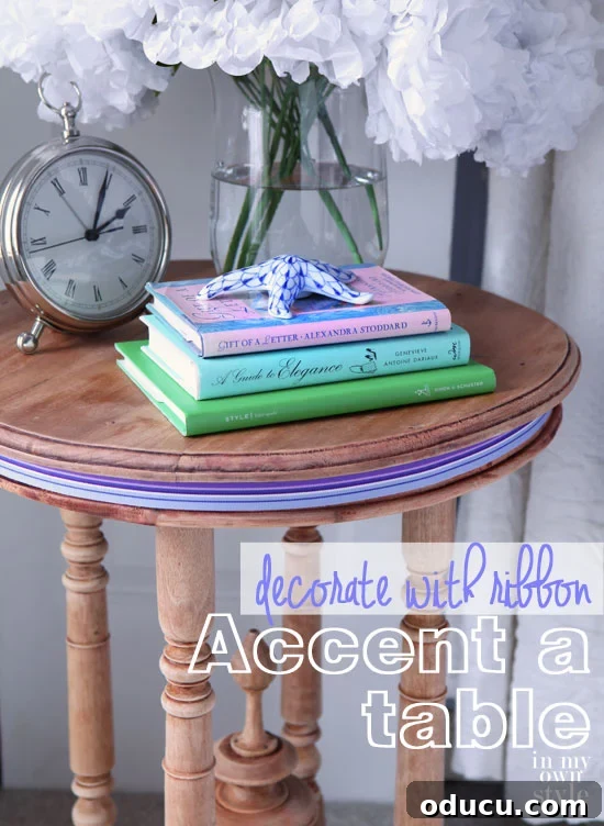Ribbon Flair for Instant Home Style 14 Round wood table with books and clock on top, featuring purple striped ribbon around its outer edge as a decorative accent.