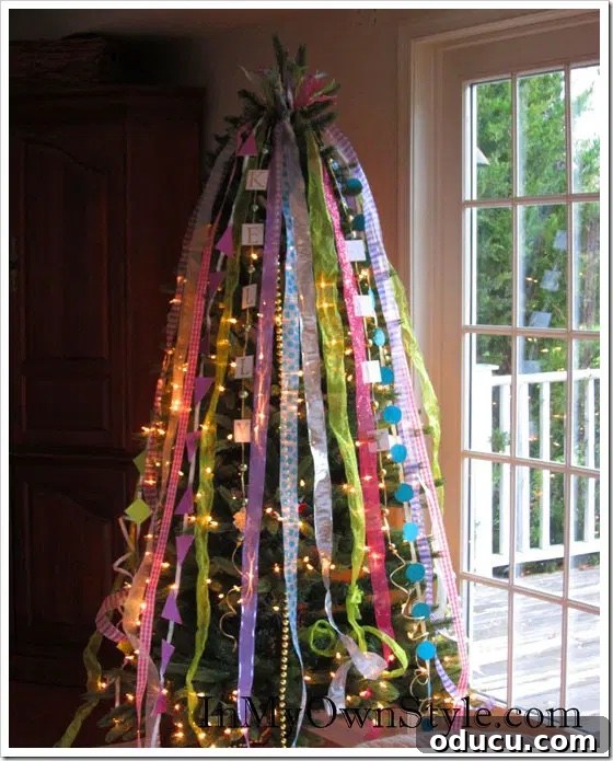 Ribbon Flair for Instant Home Style 25 Christmas tree decorated with vertically cascading ribbons of many colors, creating a unique and flowing aesthetic.