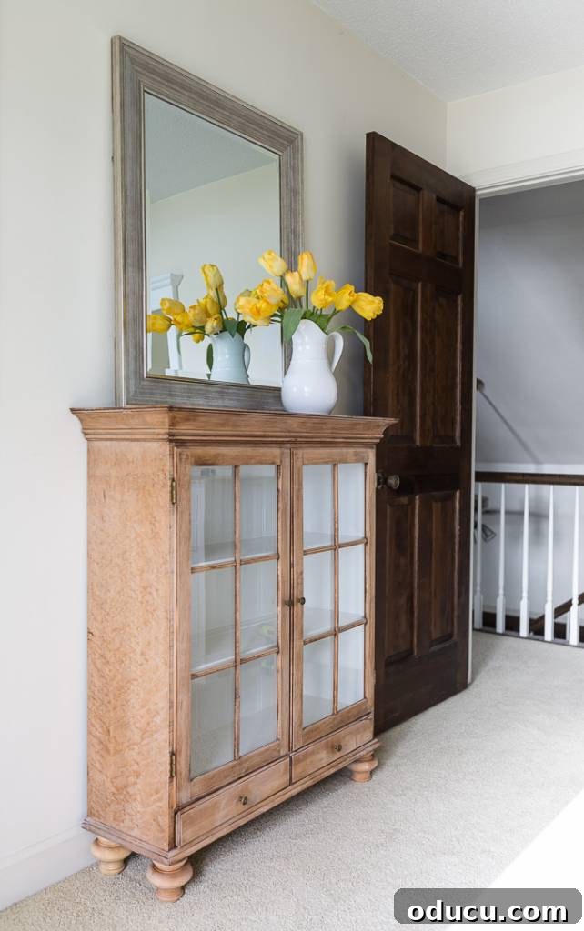 The Style Icon Who Solved My Decorating Dilemma 11 a stripped glass fronted cabinet used as a sideboard