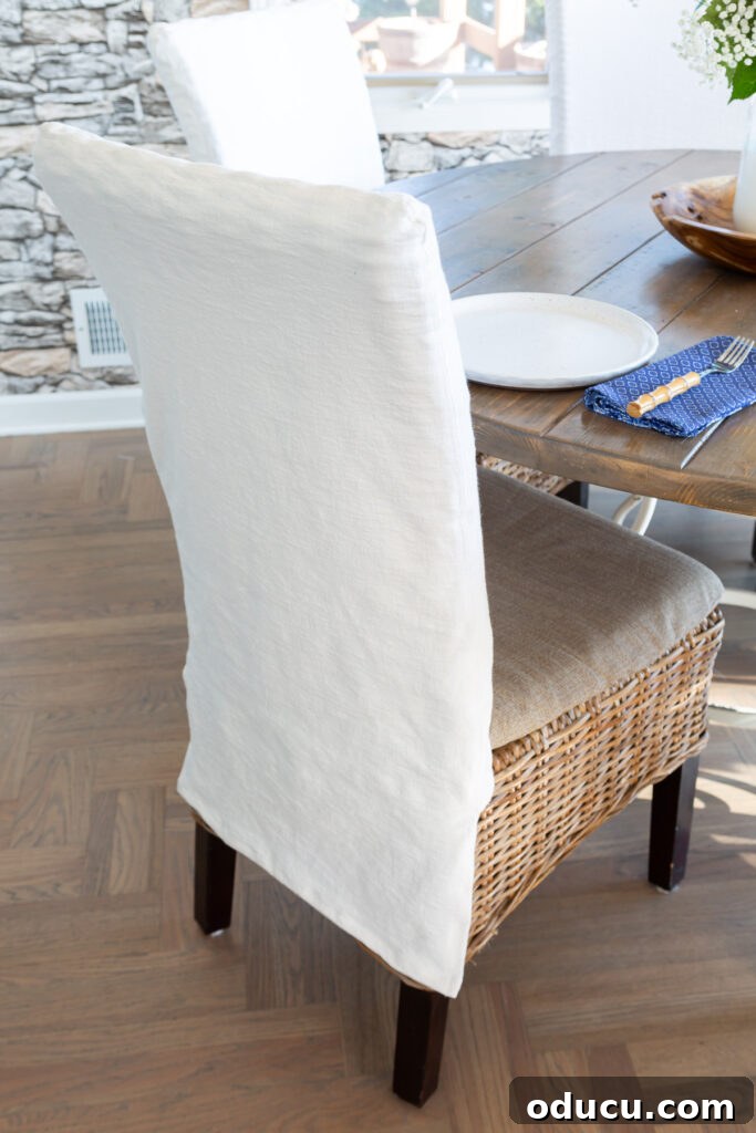 The Style Icon Who Solved My Decorating Dilemma 7 newly made white fabric slipcover on kitchen dining chair.