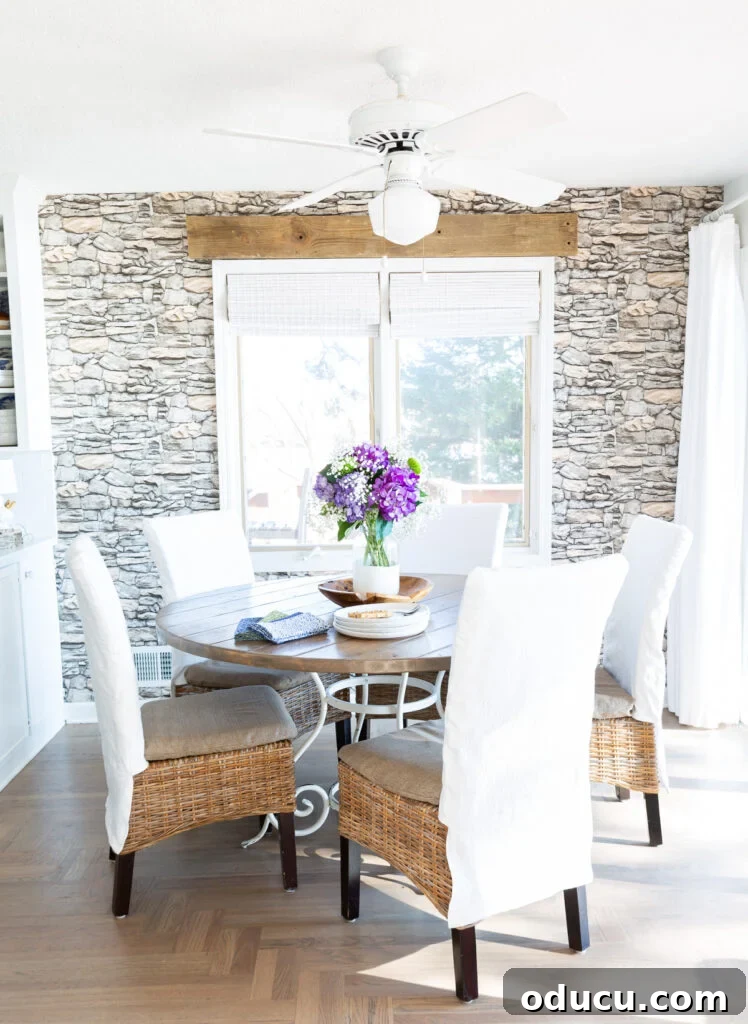 The Style Icon Who Solved My Decorating Dilemma 8 Kitchen table with 5 dining chairs around it each with a white slipcover.