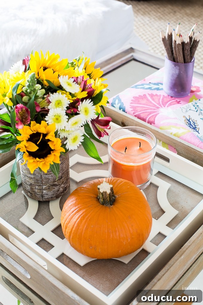 Effortless Autumn Pumpkin Decorating 16 A stylish fall coffee table arrangement featuring trays, candles, and a perfectly placed pumpkin, showcasing eclectic autumn home decor.
