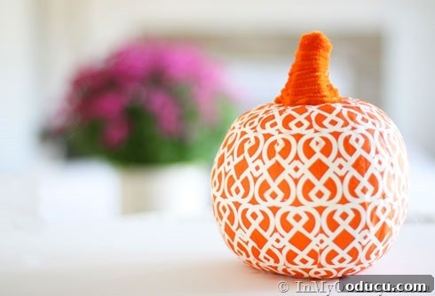 Effortless Autumn Pumpkin Decorating 10 A decorative pumpkin covered with a patterned paper napkin using decoupage, offering a unique and personalized fall decoration.