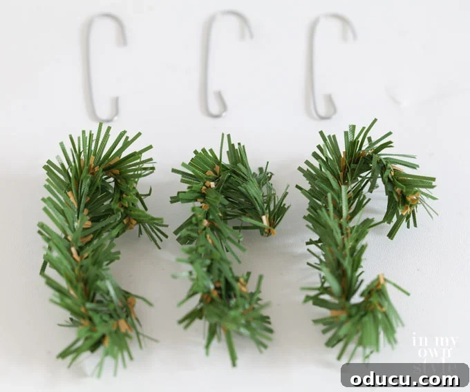 Cut pieces of a garland tie shaped into Christmas ornament hooks, designed to blend in.