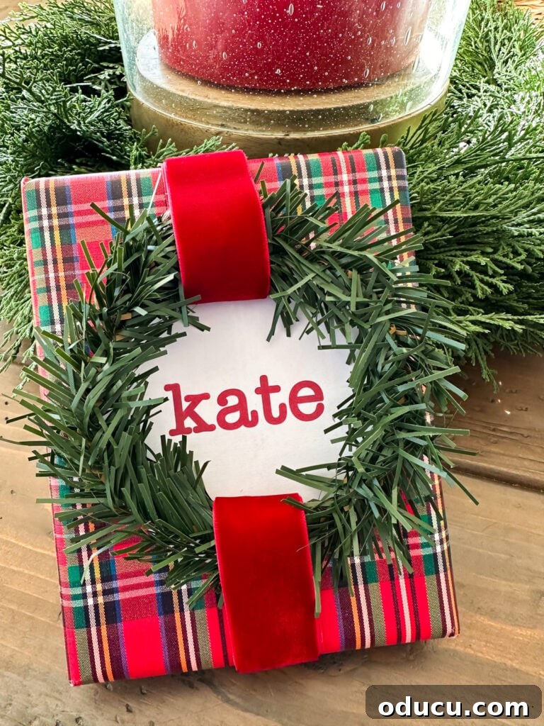 A Christmas garland tie shaped into a wreath used as an accent on a gift-wrapped present, instead of a bow.