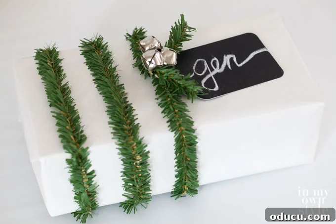 Christmas gift wrap idea using three garland ties on a wrapped gift box, creating a festive band.