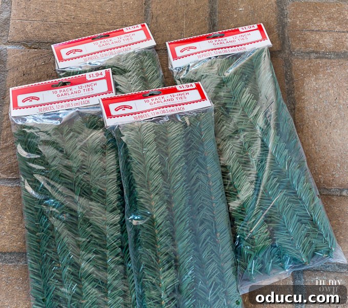 Four unopened packages of Christmas garland ties, showcasing their simple yet effective design.