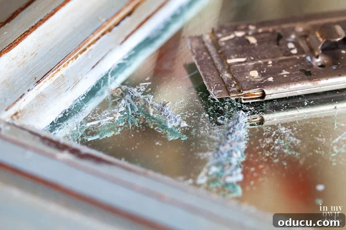 The Annie Sloan Secret to a Stunning Mirror Makeover 9 How to clean paint off a mirror or glass using a razor blade scraper and glass cleaner.