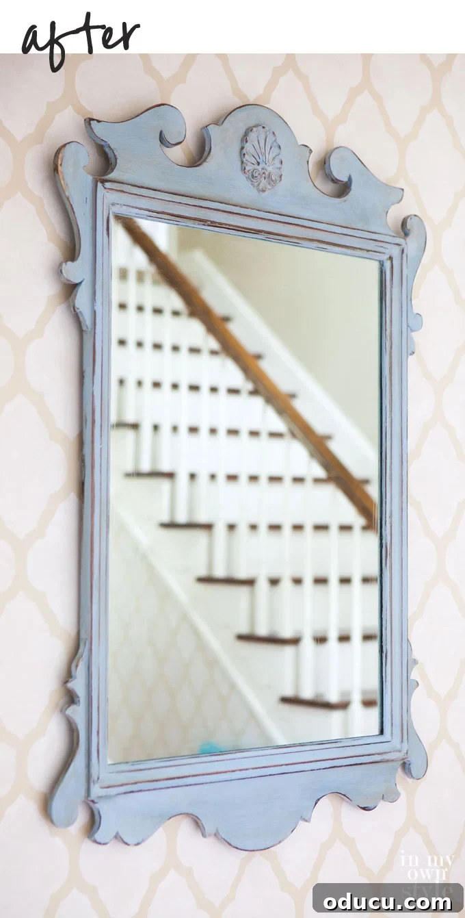 The Annie Sloan Secret to a Stunning Mirror Makeover 10 Finished aged and distressed mirror using Annie Sloan chalk paint and dark wax, displayed in a foyer.