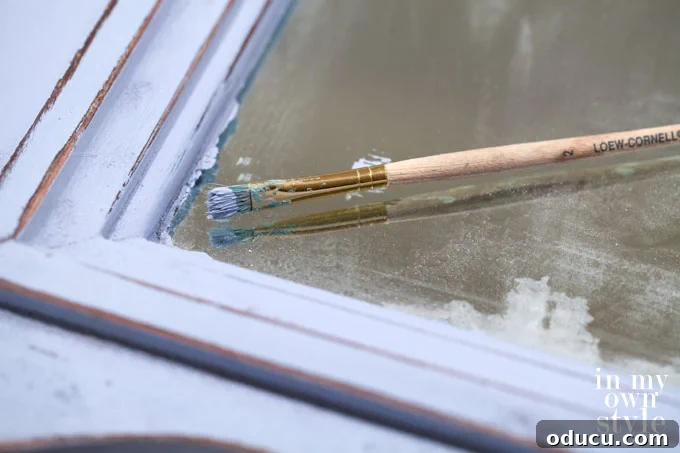 The Annie Sloan Secret to a Stunning Mirror Makeover 6 Furniture painting tips for painting a mirror frame, showing how to protect the mirror glass.