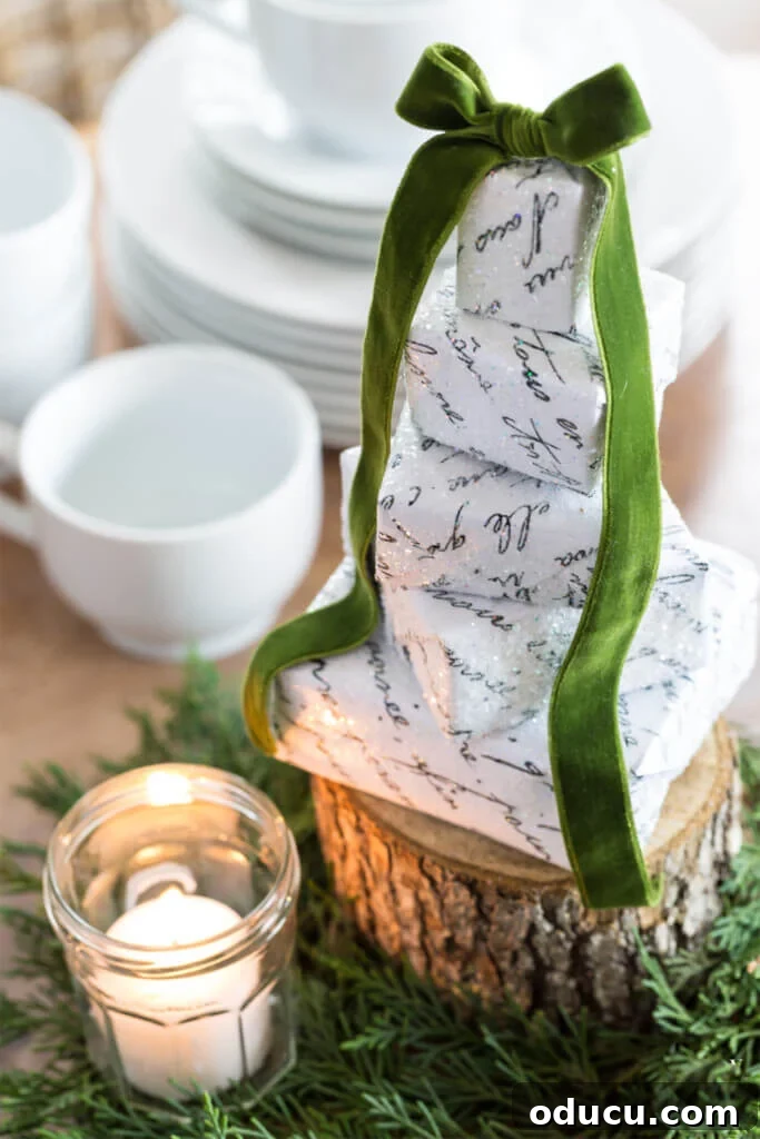 Mastering Ribbon Bows: Simple Steps for Gifts, Wreaths, and Decor 2 Stack of small boxes wrapped in white and black script lettering paper for Christmas.