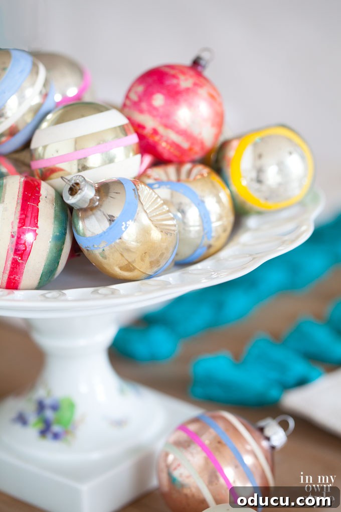 Brilliant Christmas Decorating Ideas 9 Display of vintage Christmas ornaments on a pedestal