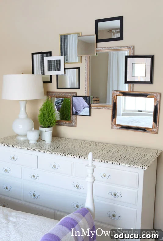 Your Welcome Space Awaits 3 3D-Gallery-wall-using-framed-mirrors - A beautifully styled dresser with a mirror gallery wall above