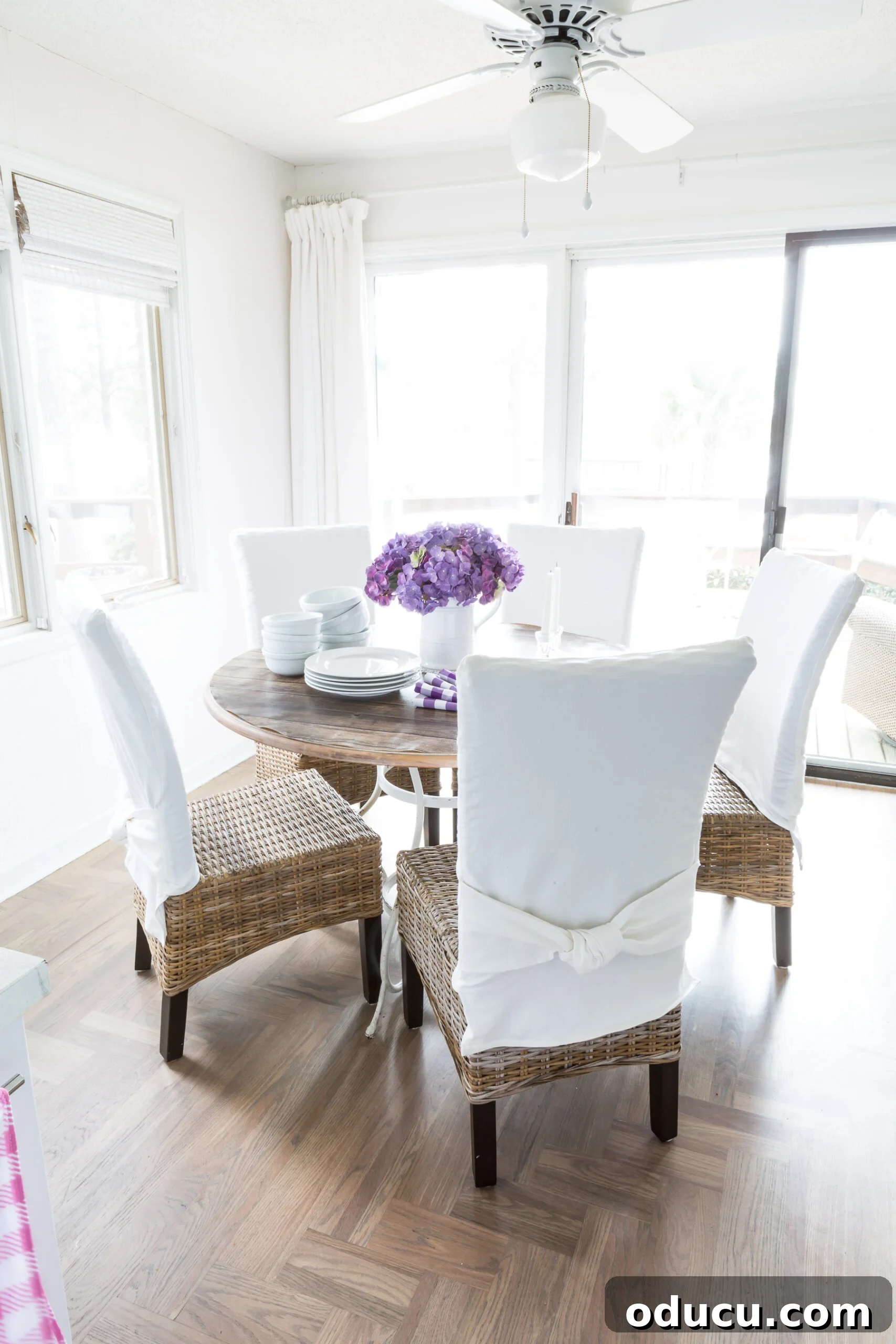 Transform Your Dining Chairs with Easy DIY Slipcovers 6 Simple spring dining room decor. A bright and airy dining space featuring chairs with adaptable slipcovers, proving their versatility across different furniture styles.