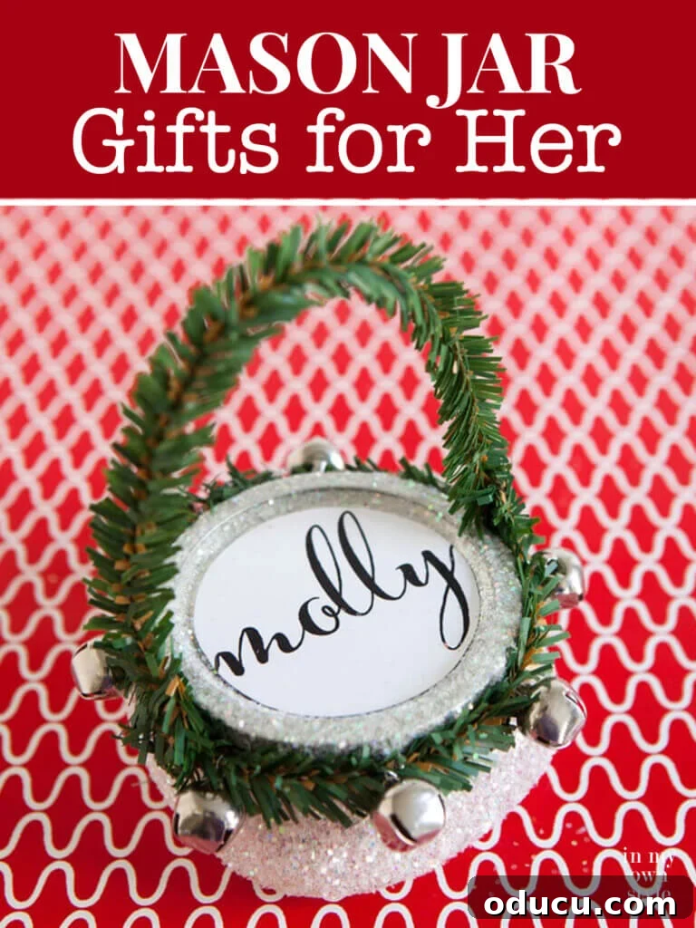 DIY Christmas Gift Jars: A Festive Alternative to Bags 7 A close-up of a pint-sized Mason jar, exquisitely transformed into a cute, glittery Christmas gift bag, with text overlay: 'Mason Jar Gifts for Her.'