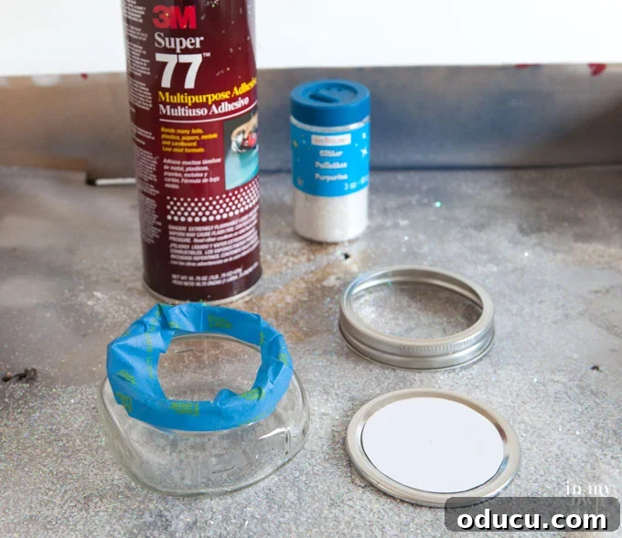 Instructions on applying spray glue to a Mason jar for glitter, showing the taped screw edge for a clean finish.