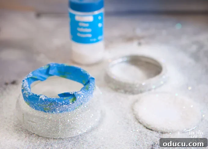 A Mason jar being glittered, illustrating how to add a sparkling finish to glass for Christmas gift ideas.