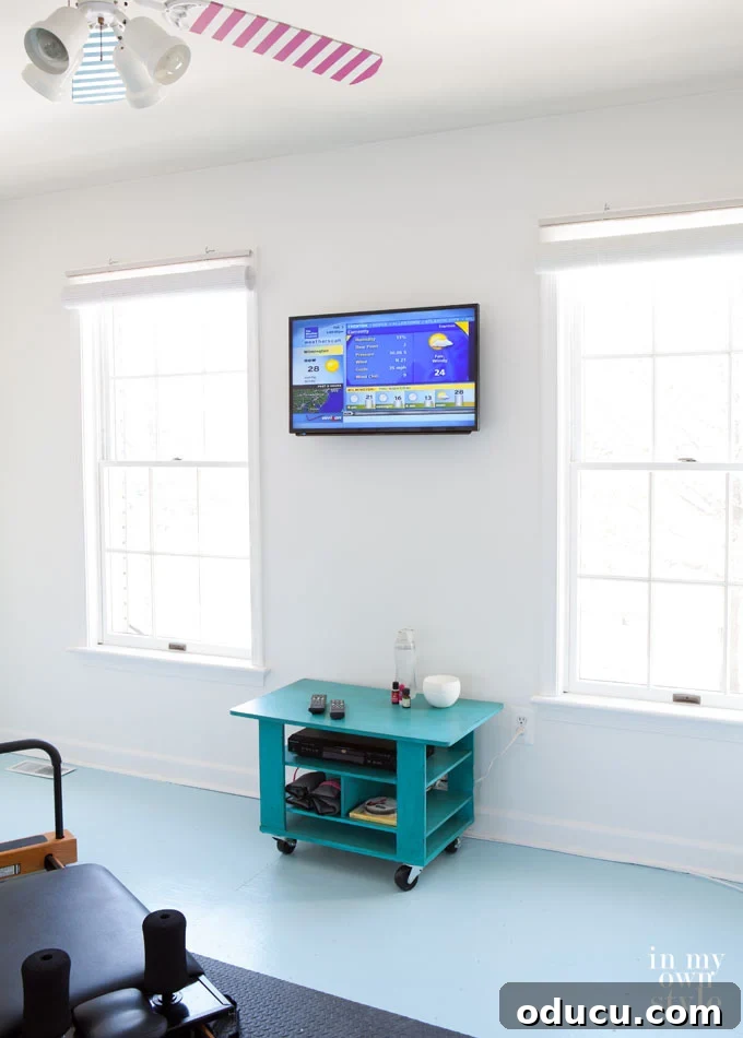 How-to-mount-a-flat-screen-TV-on-a-wall and hide the cords A mounted-flat-screen-TV-on-a-wall in a fitness room with the cords now hidden in wall.