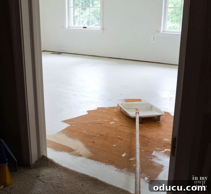 Fitness Room Transformation 9 Painting a subfloor in a bedroom with floor paint.